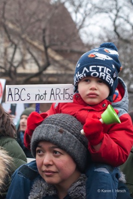 Toddler piggyback on woman holding sign ABC not AR-15s